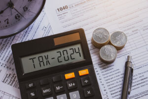 Tax 2024 word on calculator. Pay tax in 2024 years. The new year 2024 tax concept.