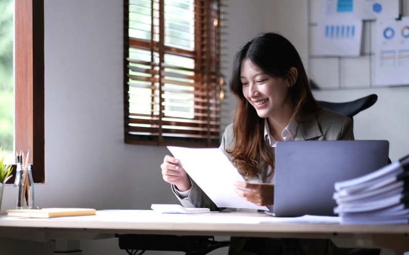 Asian businesswoman working in the office with working documents.